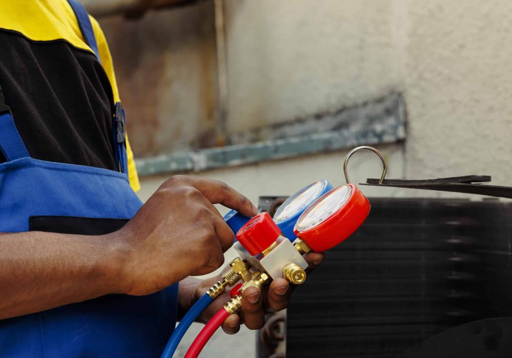 Close up of manometers able to detect hvac system moisture intrusion, refrigerant not circulating and other issues. Trained engineer using barometer set to read air conditioner pressure levels